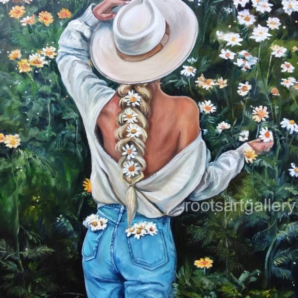 The girl with hat in field of daisies